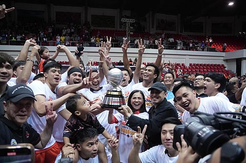 QUEZON Province Governor Helen Tan and son, Provincial Board Member Kim Tan, lift the South Division trophy after the Quezon Huskers beat Biñan Tatak Gel, 56-49, in Game 5 of their MPBL best-of-five division finals late Saturday.