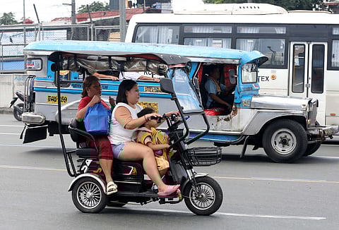 A private e-trike travels along Commonwealth Avenue in Quezon City, a route where the use of light electric vehicles on national roads will be prohibited starting 2 January 2026, as part of government efforts to ensure road safety and proper regulation of e-trikes and e-bikes.