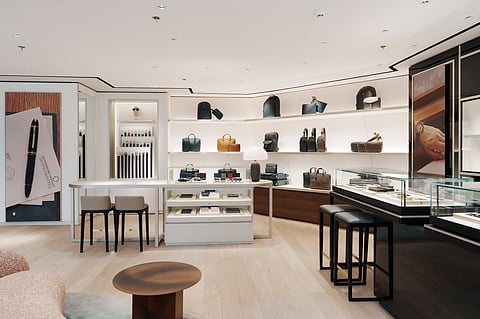 TRAVERTINE walls, dark oak, brass, and paper-inspired finishes create a tranquil backdrop in Montblanc’s new boutique inside Rustan’s Shangri-La Plaza.