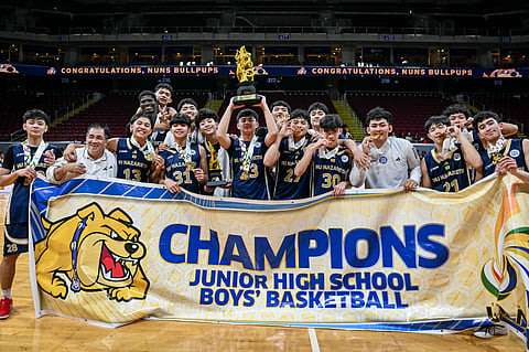 MEMBERS of the National University-Nazareth School celebrate after beating Far Eastern University-Diliman, 82-72, to sweep the UAAP Season 88 junior high school basketball tournament on Wednesday.