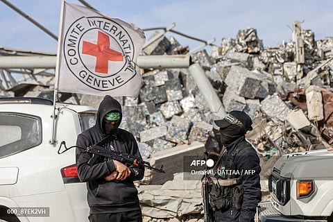 PALESTINIAN-ISRAEL-CONFLICT
Palestinian Hamas militants secure the area as Egyptian workers accompanied by members of the International Committee of the Red Cross (ICRC) search for the remains of the last Israeli hostage in the Zeitoun neighbourhood of Gaza City on December 8, 2025. Qatar and Egypt, guarantors of the Gaza ceasefire, called for the withdrawal of Israeli troops and the deployment of an international stabilisation force as the necessary next steps in fully implementing the fragile agreement. The measures were spelt out in the US- and UN-backed peace plan that has largely halted fighting, though the warring parties have yet to agree on how to move forward from the deal's first phase. Its initial steps saw Israeli troops pull back behind a so-called "yellow line" within Gaza's borders, while Palestinian militant group Hamas released the living hostages it still held and handed over the remains of all but one of the deceased.