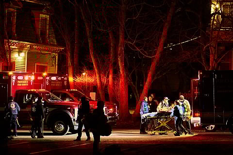First responders with the Providence Fire Department maneuver an empty stretcher near the Barus & Holley building, home to the engineering and physics departments and the site of a mass shooting, at Brown University campus in Providence, Rhode Island, on December 13, 2025. A gunman killed two people and critically wounded eight others in the afternoon of December 13 at prestigious Brown University, authorities said, urging people in the area to remain in lockdown as the attacker was still at large.