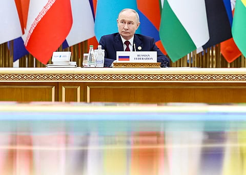 In this pool photograph distributed by the Russian state agency Sputnik, Russia's President Vladimir Putin attends an international forum dedicated to the 30th anniversary of Turkmenistan's "permanent neutrality" status in Ashgabat on 12 December 2025.