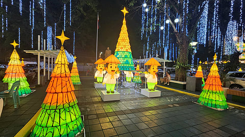GLOWING parol-inspired Christmas trees borne by four figures of Queño, the city’s mascot.