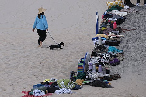 Belongings of members of the Jewish community are seen at the scene of a shooting at Bondi Beach in Sydney on December 15, 2025. Two gunmen who shot and killed 15 people at a Jewish celebration on Sydney's iconic Bondi Beach were a 50-year-old father and his 24-year-old son, Australian police said.