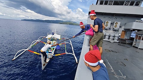 BRP Tagbanua (LC296) giving out food packs to fishermen encountered during maritime patrol.