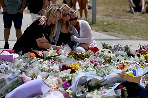 MOURNERS gather near floral tributes at the Bondi Pavilion to honour victims of the Bondi Beach Shooting in Sydney, Australia, on 15 December 2025.