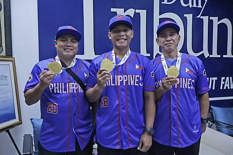 NATIONAL team coach Orlando Binarao (right) and players Romeo Jasmin (left) and Mark Beronilla display their gold medals that they won from the men’s baseball competition of the 33rd Southeast Asian Games.