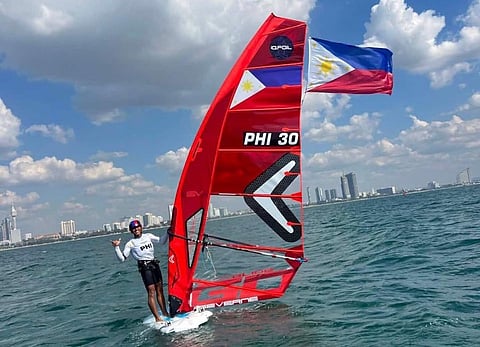 JOHN Castillo proudly flies the national colors after winning a gold medal in the surfing competition of the 33rd Southeast Asian Games.