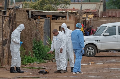 POLICE forensic agents gesture at the scene of an attack at a tavern in Bekkersdal on 21 December 2025.
