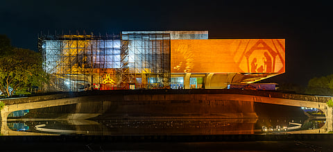 THE CCP Main Building glows in warm hues of red and orange, transforming its iconic facade into a parol-inspired beacon guiding the Simbang Gabi faithful
