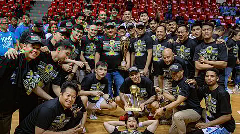 ABRA Solid North Weavers owner JB Bernos holds the MPBL National Championship trophy as he celebrates with his team after completing a three-game sweep of the Quezon Huskers.