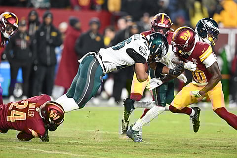 SAQUON Barkley gets entangled in a dogfight as he powered the Philadelphia Eagles to a 29-18 win over the Washington Commanders that assured them a spot in the NFL playoffs.