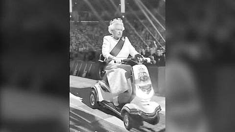 AI_GENERATED Queen Elizabeth II rides a scooter to a wrestling match.