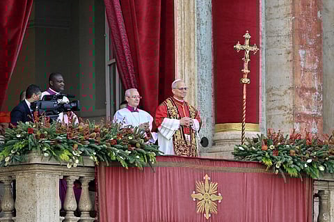 Pope Leo XIV makes an appearance at the main balcony of St. Peter's basilica to deliver the Urbi et Orbi message and blessing to the city and the world as part of Christmas celebrations, at St Peter's square in the Vatican on December 25, 2025.