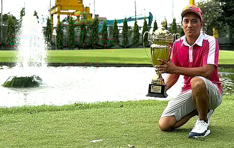 DA Clores shows off his trophy behind the 18th green at Veterans Golf Club following his dominant performance in the Teaching Pro division of the PGAP Year-End tournament on Monday.