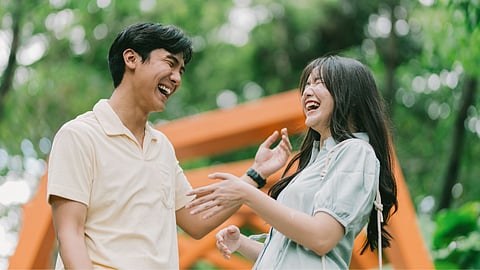 A COUPLE shares a light moment, highlighting the importance of present connection amid the rise of future-faking in dating.