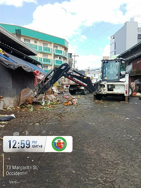 PERSONNEL from the Bacolod Environment and Natural Resources Office and the City Engineer’s Office lead a waste-hauling operation at Libertad South Market on Tuesday as the city prepares for a major transition in 2026, having tapped a Luzon-based consortium to manage garbage collection, hauling and sanitary landfill operations.