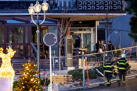 Rescuers are seen at the site of an explosion that ripped through the bar Le Constellation in Crans-Montana on January 1, 2026. Several people were killed and others injured when an explosion ripped through a bar in the luxury Alpine ski resort town of Crans Montana, Swiss police said early on January 1.