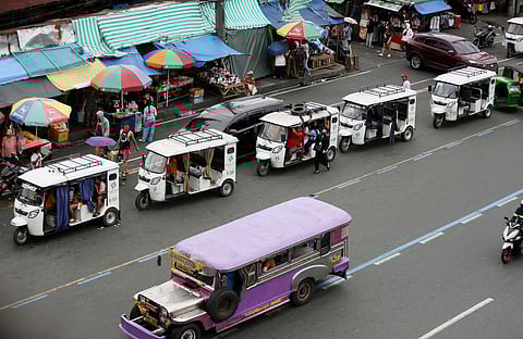 DESPITE the ban on electric bikes and electric trikes imposed by the Land Transportation Office, an e-trike is seen picking up passengers along Commonwealth Avenue in Quezon City on Friday. The LTO announced that it is starting to apprehend violators to improve road safety and traffic flow on major thoroughfares.