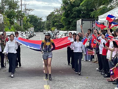 A COLOR guard composed of second-generation Taiwanese business members carries the ROC flag, symbolizing heritage, continuity, and community unity.