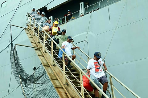 The Philippine Coast Guard (PCG) facilitated the turnover of three fisherfolk rescued by a United States (U.S.) Navy vessel, USNS Cesar Chavez (T-AKE 14), approximately 50 nautical miles west of Bolinao, Pangasinan, on January 1, 2026. (Photo courtesy of PCG)