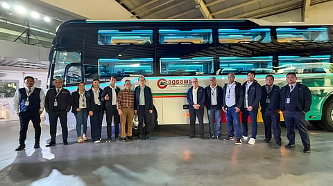 BJ Mercantile and Cagsawa Travel and Tours executives stand beside one of the newly delivered THACO sleeper buses during the handover ceremony.