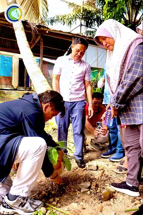 CLIMATE Change Commission vice chairperson and executive director Robert E.A. Borje plants a malugay (Pometia pinnata) seedling at the College of Forestry of Cotabato State University, as CSU president Sema Dilna (center) and his team look on.