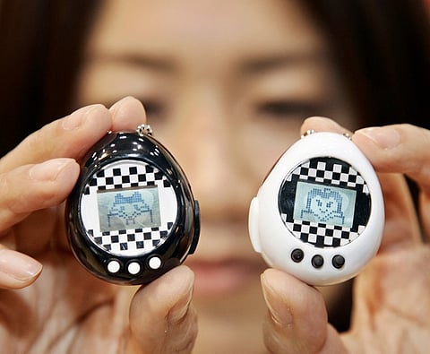 A JAPANESE toy giant Bandai employee displays the tiny toy of virtual pet ‘Tamagochu,’ composed by a pair of small gadgets like Bandai’s mega hit toy Tamagotchi, at the Tokyo International Gift Show 13 February 2007. Nearly half
of all Tamagotchi unit sales were in Japan and in 2025, British retailer Hamleys ranked it as one of the top 100 toys of all time, alongside the likes of Lego and the Rubik’s Cube.