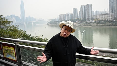 DONALD Trump’s impersonator Ryan Chen speaking as his assistant records a video along the Jialing River, in southwestern China’s Chongqing municipality.