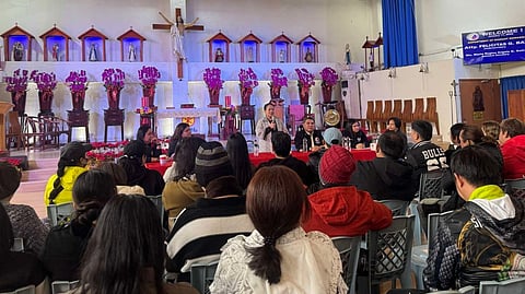 DEPARTMENT of Migrant Workers officials led by Undersecretary Felicitas Q. Bay sit down with distressed overseas Filipino workers sheltered at Bahay Ugnayan, managed by missionary priest Fr. Joy Tajonera (inset), on Sunday in Taiwan. DMW Secretary Hans Leo Cacdac has vowed to keep their partnership with the shelter amid an earlier alleged threat by a labor attache to shut it down.