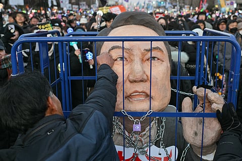 A PROTESTER calling for the ouster of then South Korea President Yoon Suk Yeol punches an effigy of him after the result of the second martial law impeachment vote outside the National Assembly in Seoul on 14 December 2024.