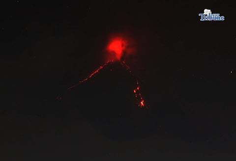 Pyroclastic density currents flow down the slopes of Mayon Volcano as seen from Legazpi City on Sunday night, 18 January 2026.