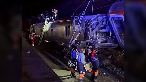 RESCUERS search a derailed train coach in Adamuz, Spain.