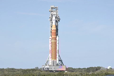 NASA’s SLS rocket towers in the horizon.