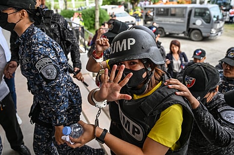FRENCHIE Mae Cumpio, a detained Filipino journalist, gestures as she arrives at Tacloban Regional Trial Court in Leyte island on 22 January, to attend the promulgation of her court case. Cumpio was found guilty of terror financing.