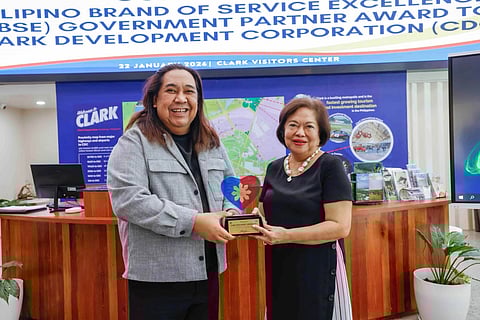 CDC President and CEO Atty. Agnes VST Devanadera receives the award from DOT Region 3 Director Richard Daenos, who cited the CDC’s role in elevating service standards in Clark Freeport.