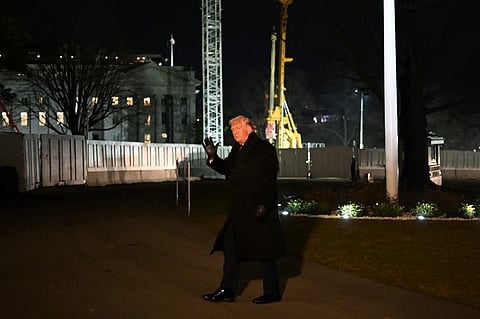 US President Donald Trump waves to the press while walking from the South Lawn upon arrival at the White House in Washington, DC on January 22, 2026. Trump returned from the World Economic Forum (WEF) in Davos, Switzerland where he backed down on threats to seize Greenland by force from ally Denmark, announcing a vague deal aimed at ensuring security of the Arctic territory on January 21, 2026.