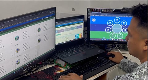 HANDS steady over the console, a military technician fine-tunes the digital nerves of the AFP Audit Management System, ensuring every command runs with precision and security.