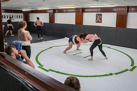 WRESTLERS Tori Moffett (left) and Toraigh Mallon practice in the ring during a sumo wrestling training session at a club in Belfast, Northern Ireland.