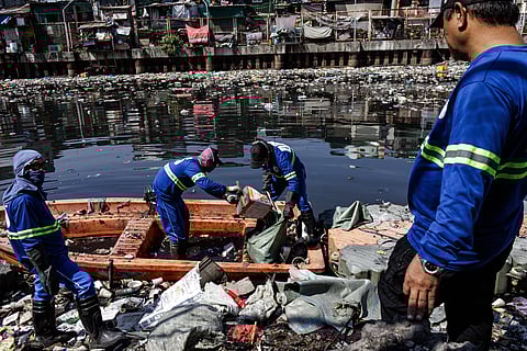 WORKERS brave the midday sun to clear garbage from Estero de Vitas in Tondo, Manila, on Monday following residents’ complaints about foul odors and waste.