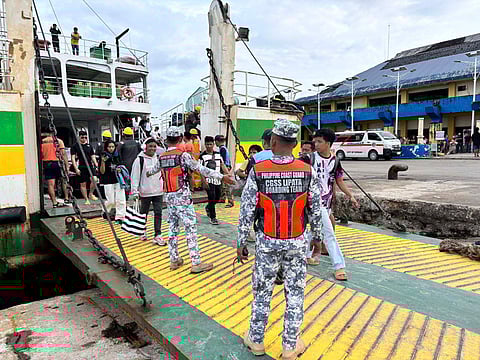 Passengers of MV Maria Felisa, traveling from San Ricardo, Southern Leyte, safely disembark at the Lipata after vessel caught fire off the water f Surigao City on Sunday.