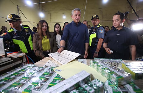 DEPARTMENT of the Interior and Local Government Secretary Jonvic Remulla (center), Philippine National Police chief PGen. Jose Melencio Nartatez (left), and Bureau of Customs Commissioner Ariel Nepomuceno (right) inspect cartons of cigarettes and machines that produce them seized in a Pampanga raid that resulted in the rescue of 65 Filipinos reportedly forced to work by six Chinese suspects at Samyoung Global Enterprises in Barangay Panipuan, Mexico, Pampanga, on Thursday.