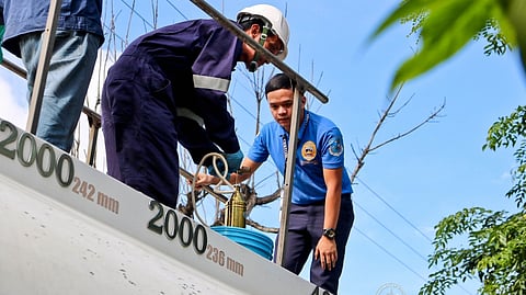 CUSTOMS personnel check the hundreds of liters of fuel that were apprehended in one of the raids of the Bureau of Customs in Batangas last year.