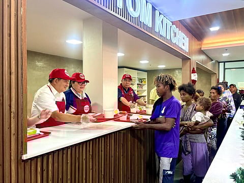 Presidential Adviser on Poverty Alleviation, Larry Gadon, assists in handing out meals for families at the DSWD's first food bank at the Nadaske Building in Pasay City