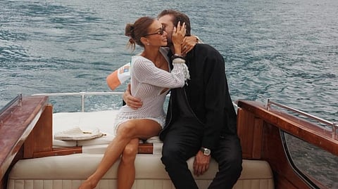 EMIL kisses Kylie’s cheek as she proudly displays her engagement ring.