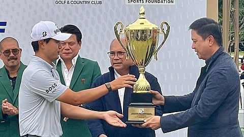 KOREAN Wooyoung Cho (left) beams with pride while receiving the PGC trophy from PSC chairman Patrick 'Pato' Gregorio during the awarding ceremony on Sunday.