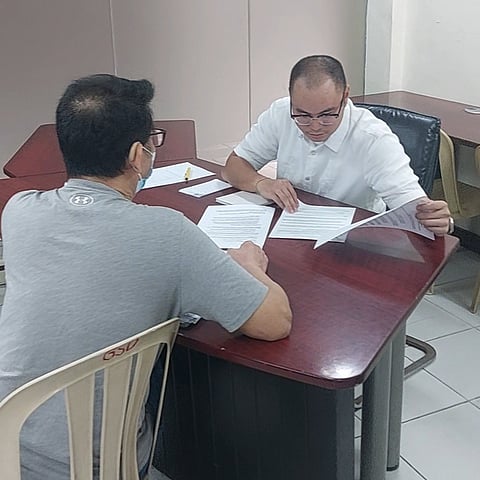 Quezon City Vice Mayor legal consultant Paul Gabriel Merida providing assistance to one of his clients during a free legal consultation at the Legislative Building of the Quezon City Hall complex this Tuesday.