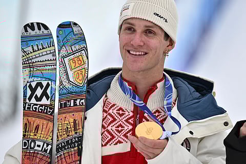Gold medallist Norway's Birk Ruud celebrates on the podium after the freestyle skiing men's freeski slopestyle final during the Milano Cortina 2026 Winter Olympic Games at Livigno Snow Park, in Livigno (Valtellina), on February 10, 2026.