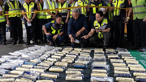 PHILIPPINE National Police Chief Police General Jose Nartatez Jr., DILG Secretary Jonvic Remulla, Customs Commissioner Ariel Nepomuceno and top officials from the Philippine Drug Enforcement Agency inspect 131 pieces of suspected shabu wrapped in plastic that was seized during a joint anti-drug operation at Manila International Container Port in Manila on Tuesday.